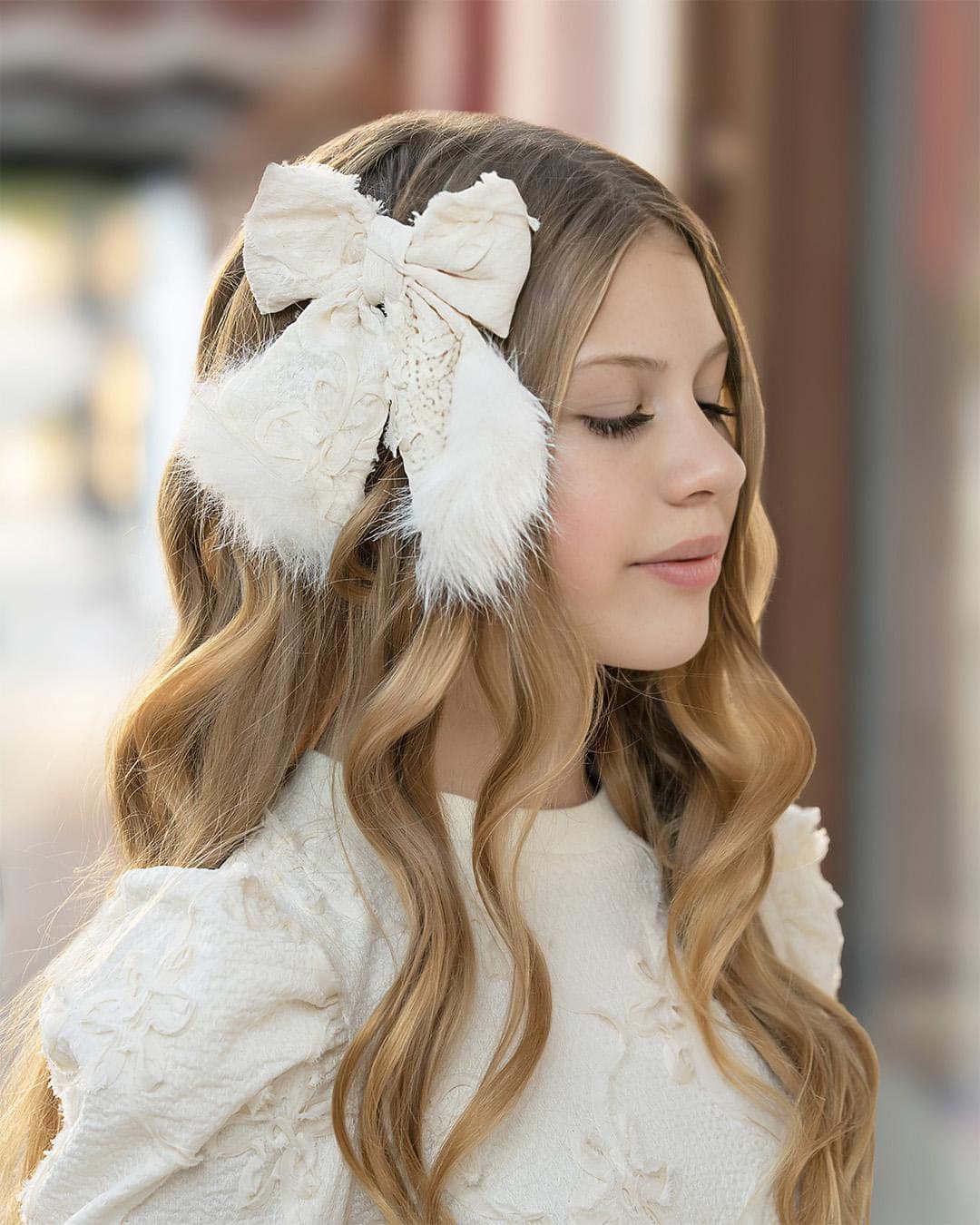 textured ivory floral bow with fur trim at the bottom. perfect to pair with any piece from the Ava collection. Especially with the wide leg pants which also has the fur trimming detail