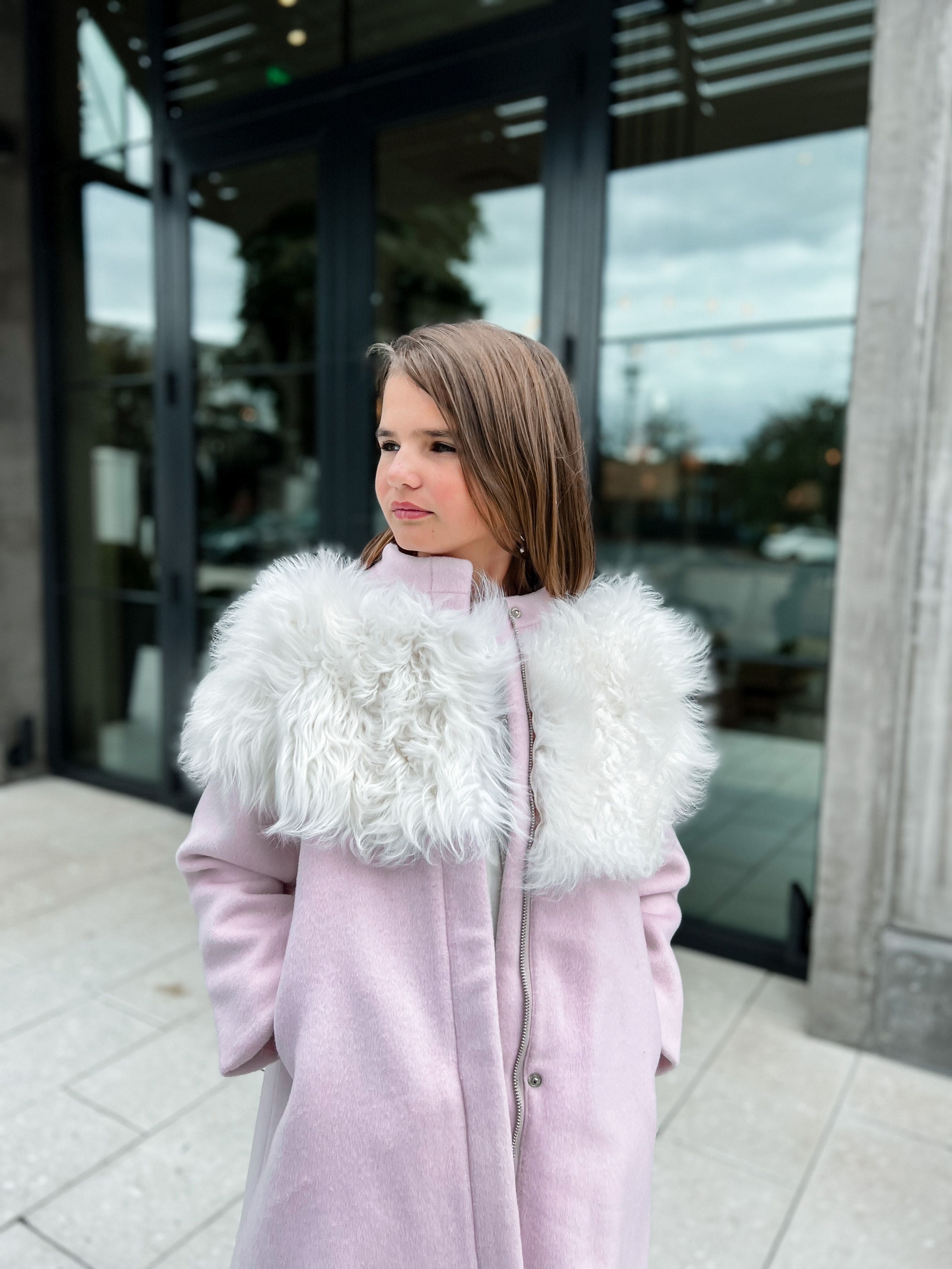 Girl wearing Faina pink wool coat with plush ivory faux fur collar, elegant blush wool winter coat styled outdoors