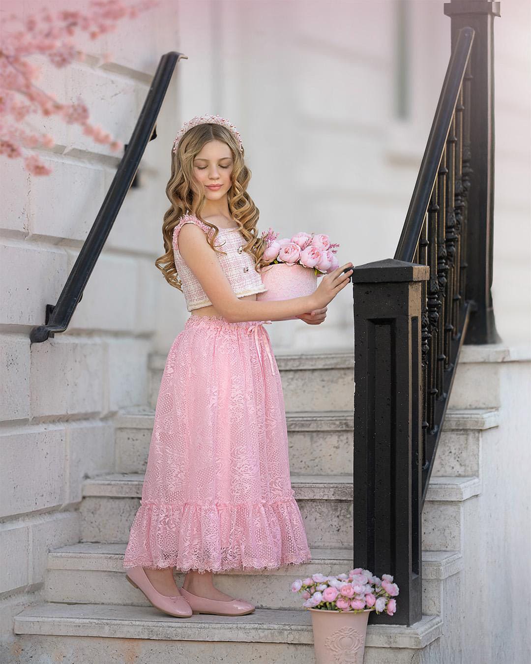 Girl wearing a beige and pink tweed top and pink lace skirt set for special occasions