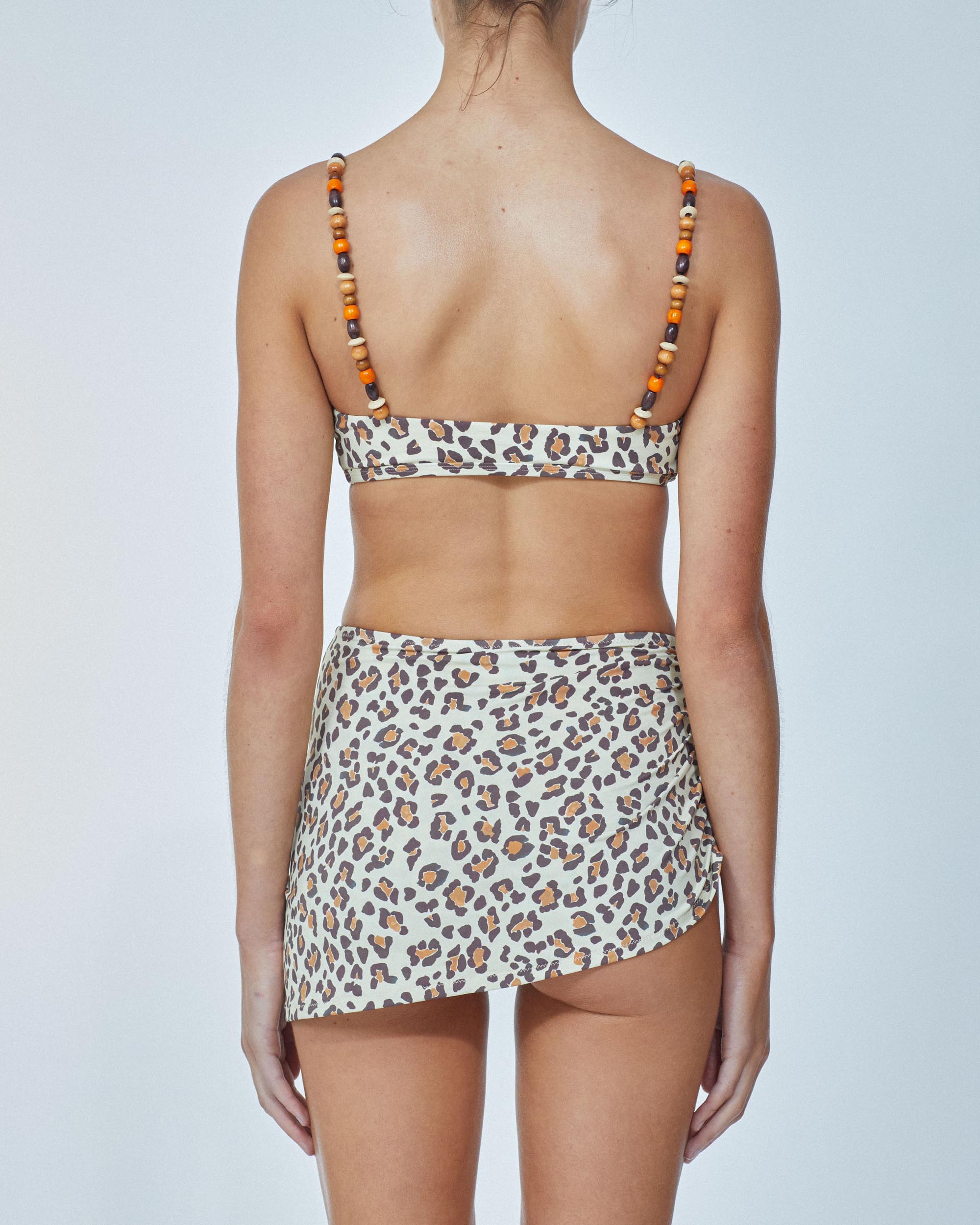 Studio image of model wearing the Crop Top in Cheetah.