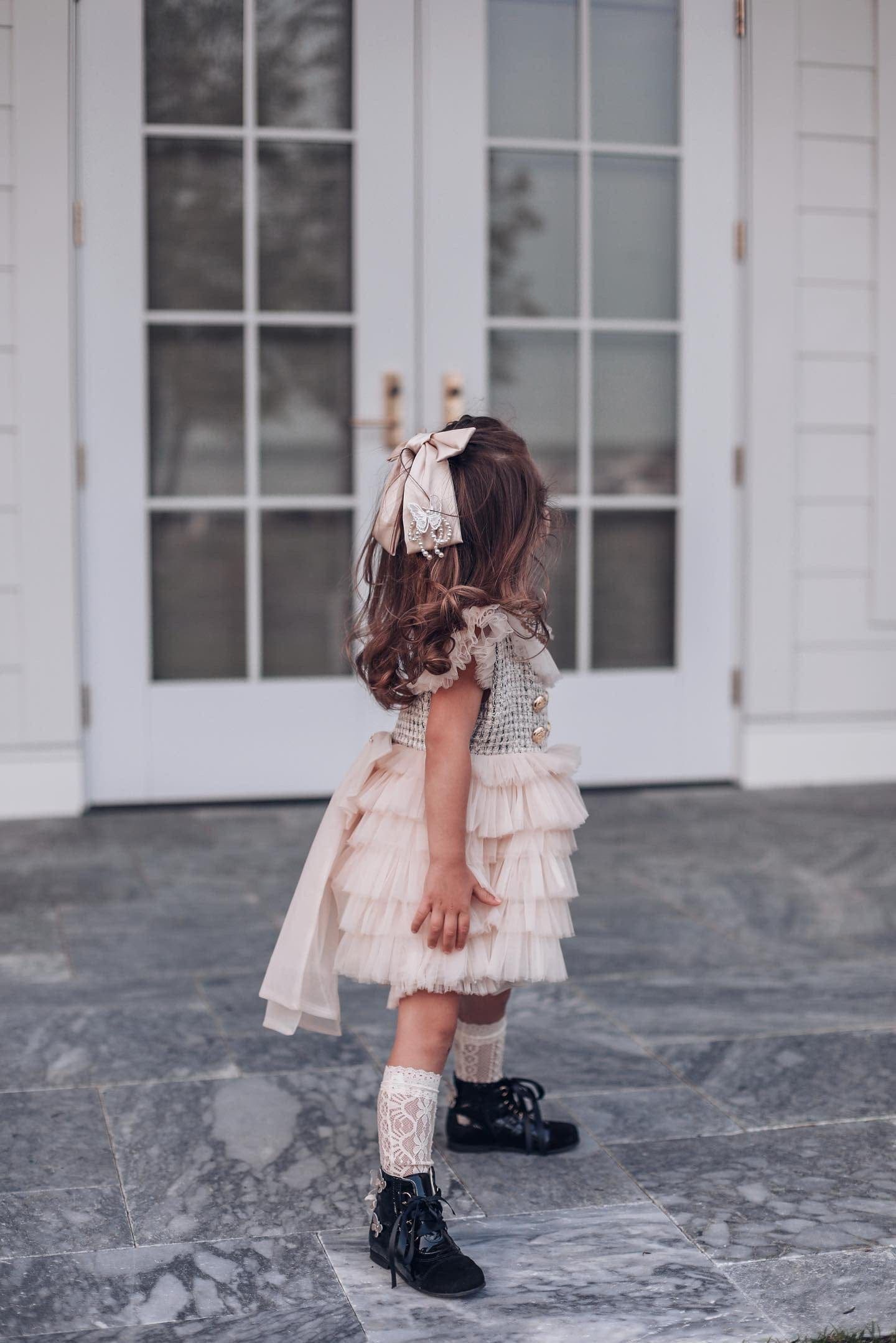 Young girl modeling Champagne Anise Satin Embroidered Hair Bow with butterfly charm