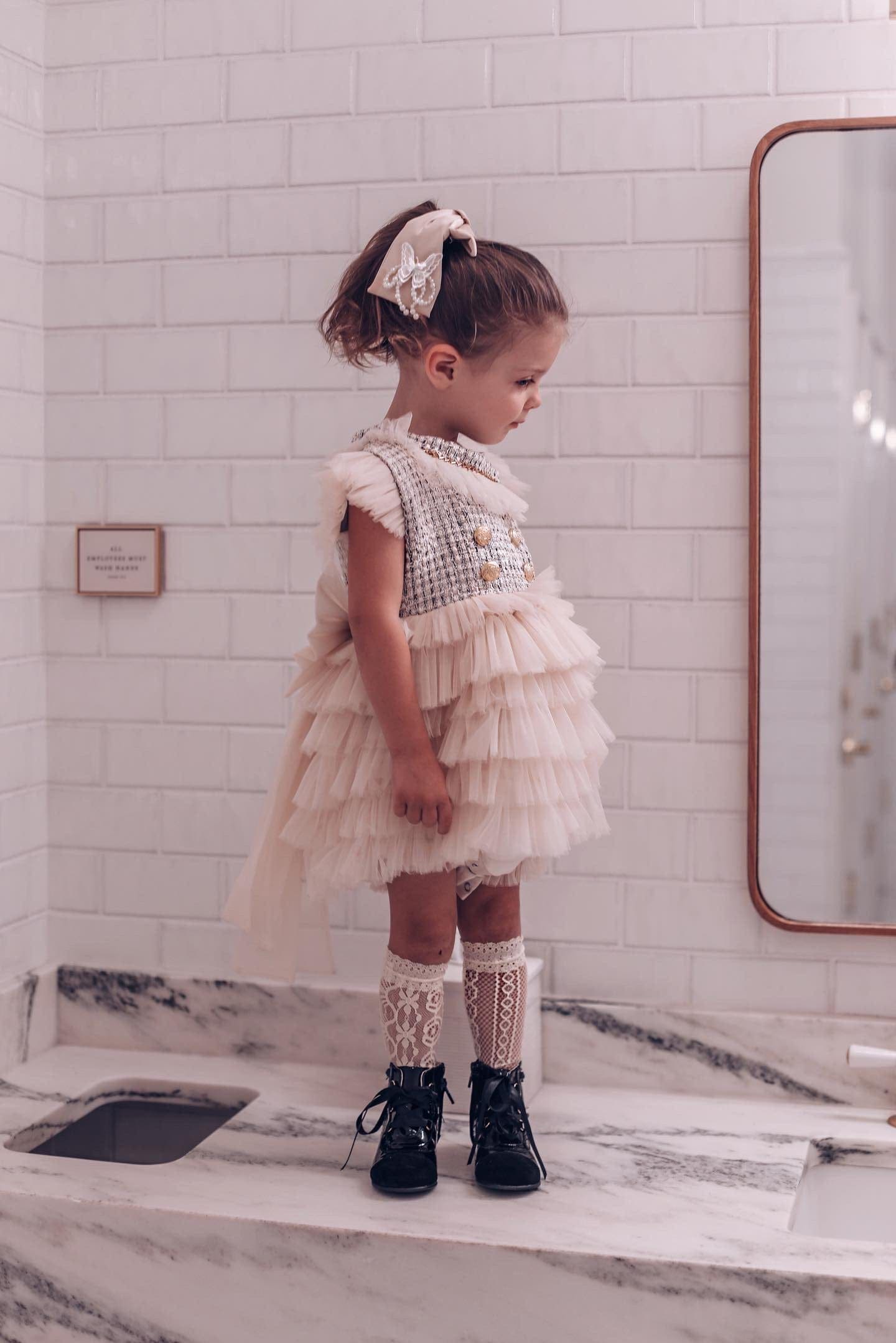 Young girl modeling Champagne Anise Satin Embroidered Hair Bow with butterfly charm