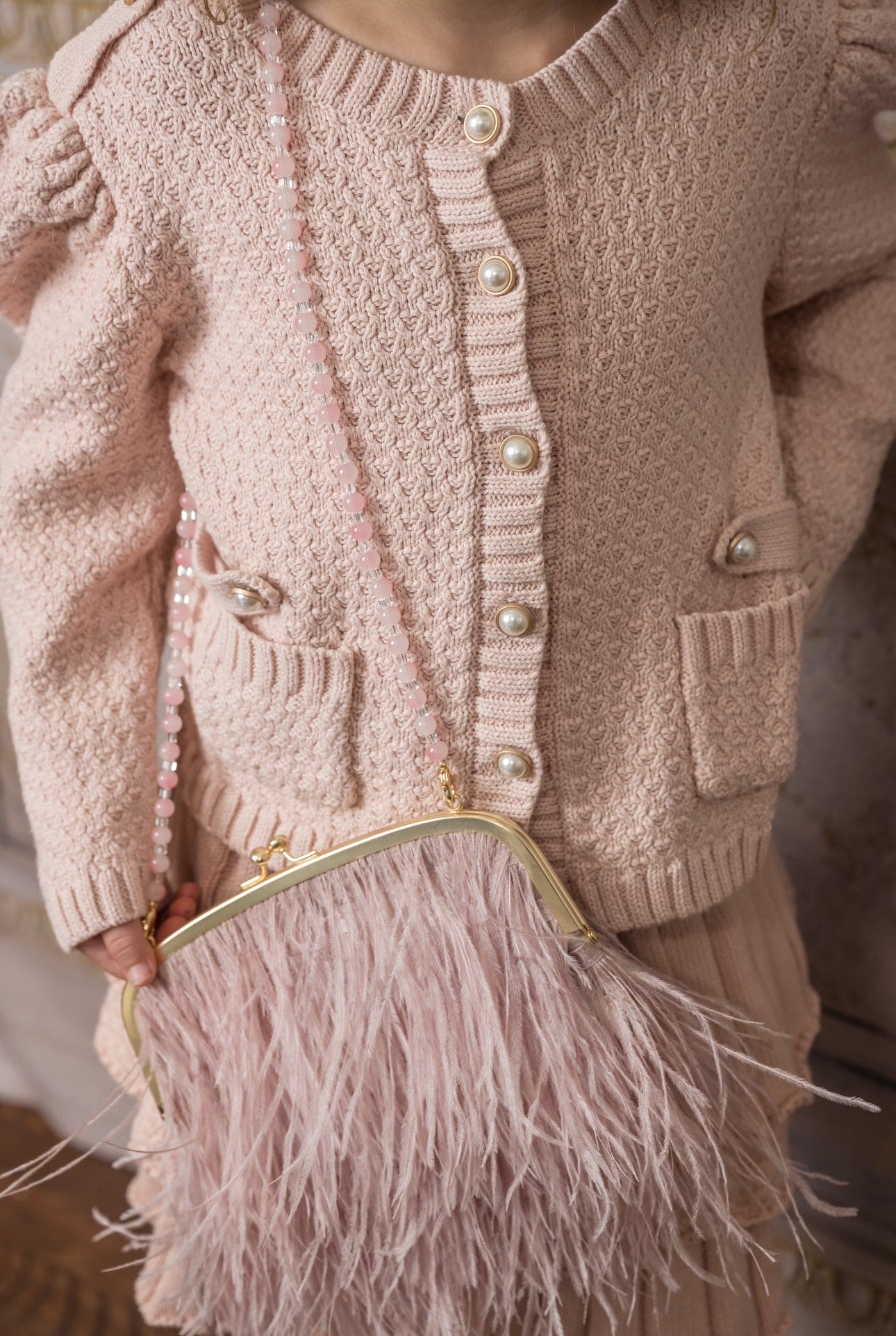 Detail of Julie pink knit cotton cardigan pearl buttons and knit pockets