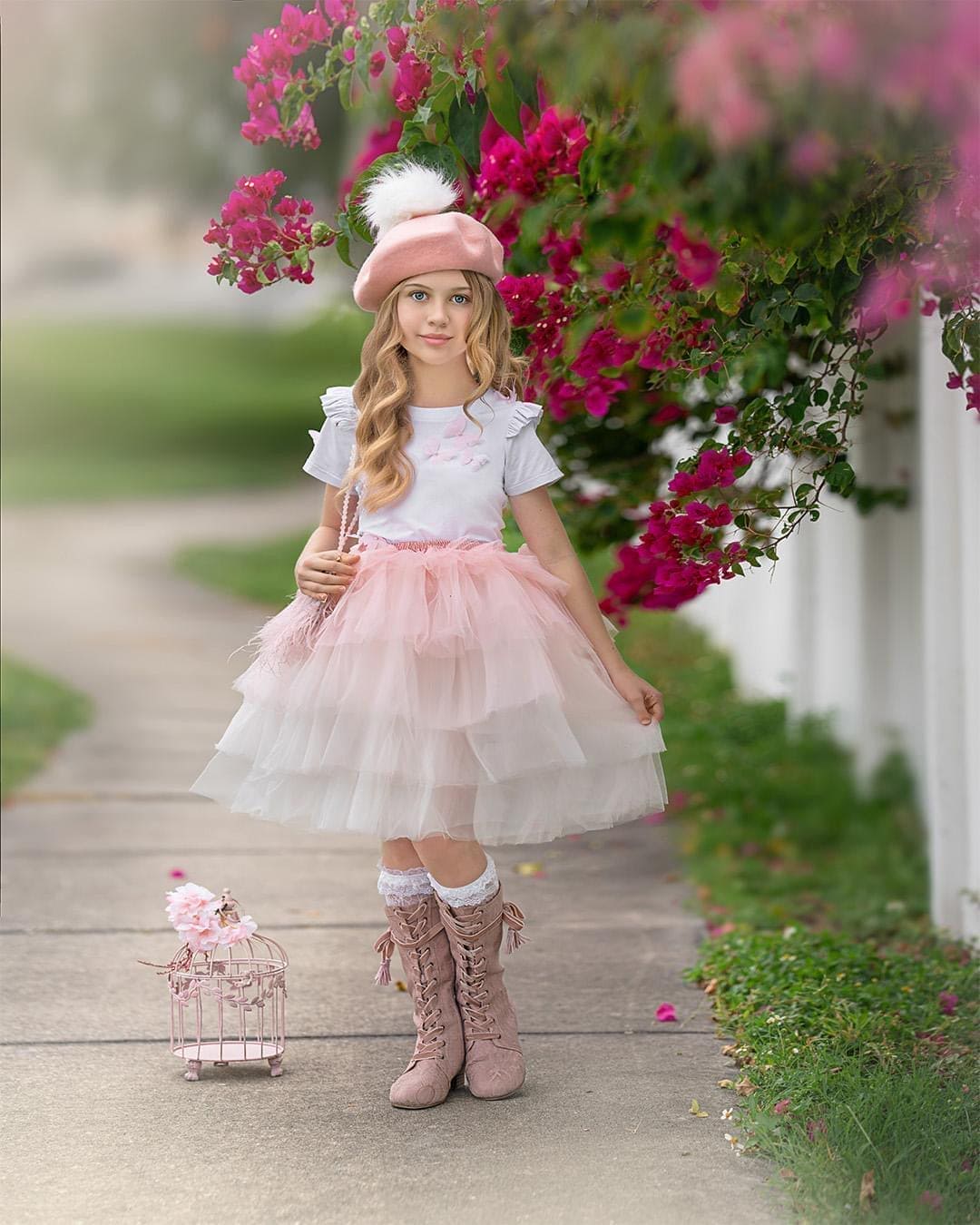 Pink ombré tutu skirt for girls featuring soft layered tulle and satin waist tie, styled for an outdoor portrait.