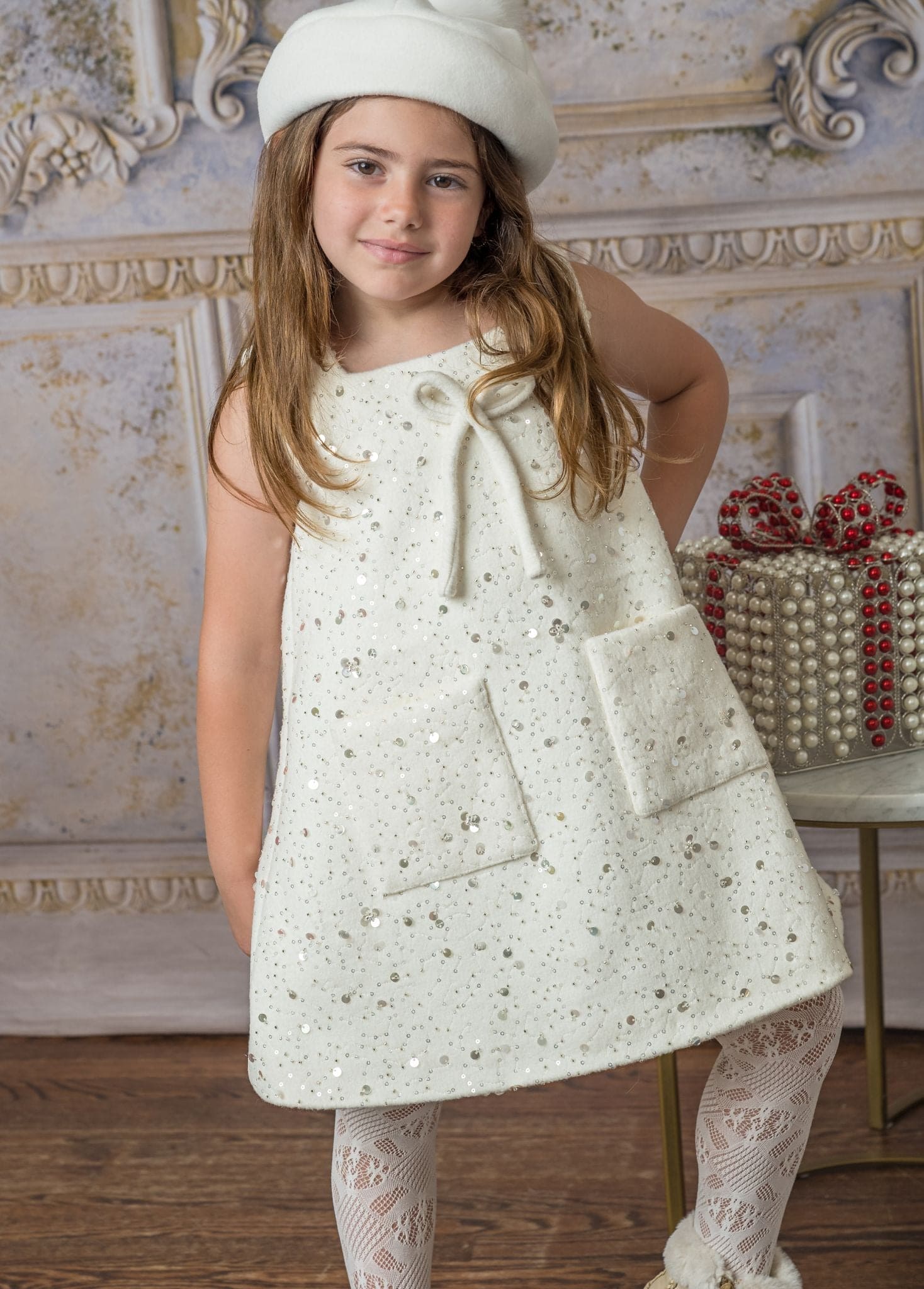 marshmallow wool dress with bow detail along with glitter and two front pocket squares. perfect for this winter season