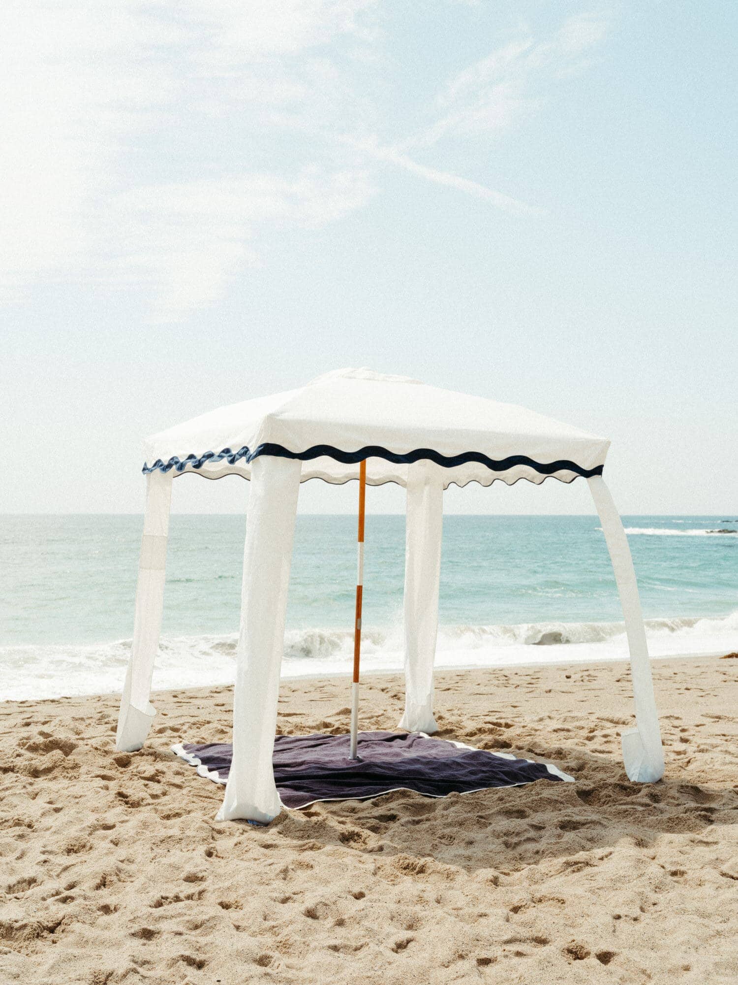 Riviera white cabana with matching accessories on the beach