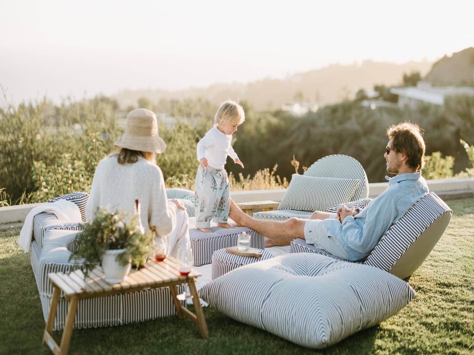 Family enjoying an outdoor picnic on the reclining lounger