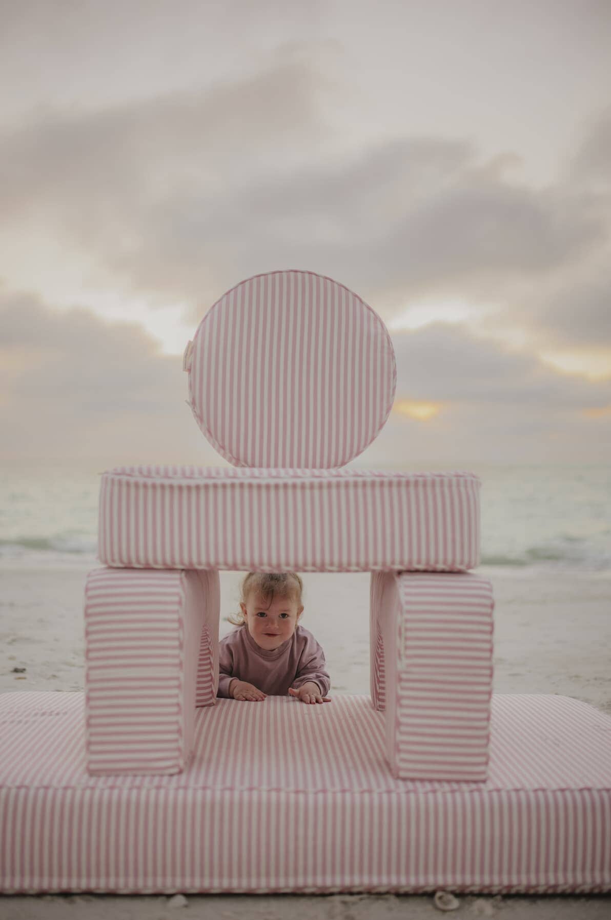 kids playing on modular pillow stack on the beach