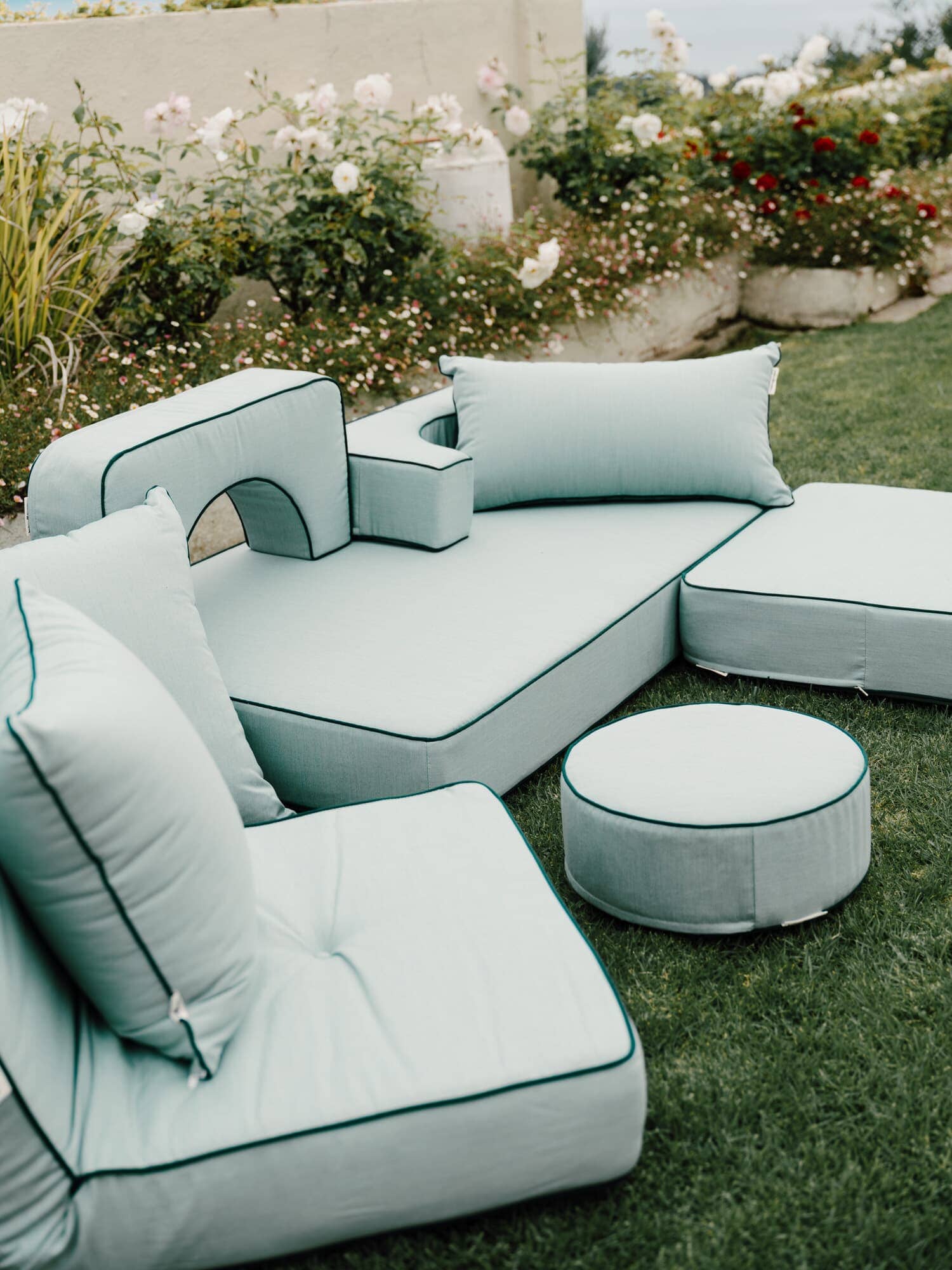 Riviera green modular pillow stack in a garden setting