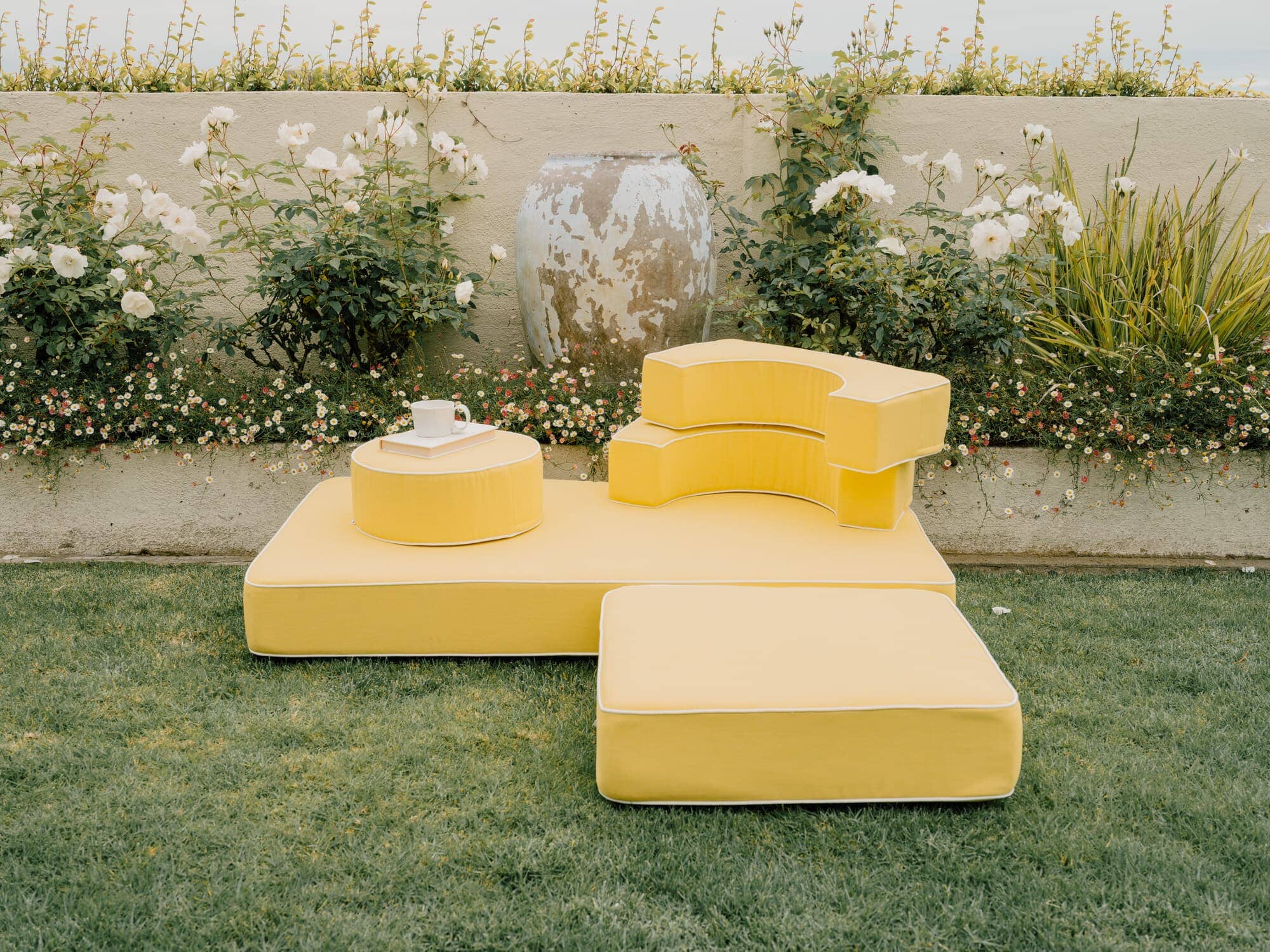 Riviera mimosa modular pillow stack in a garden setting