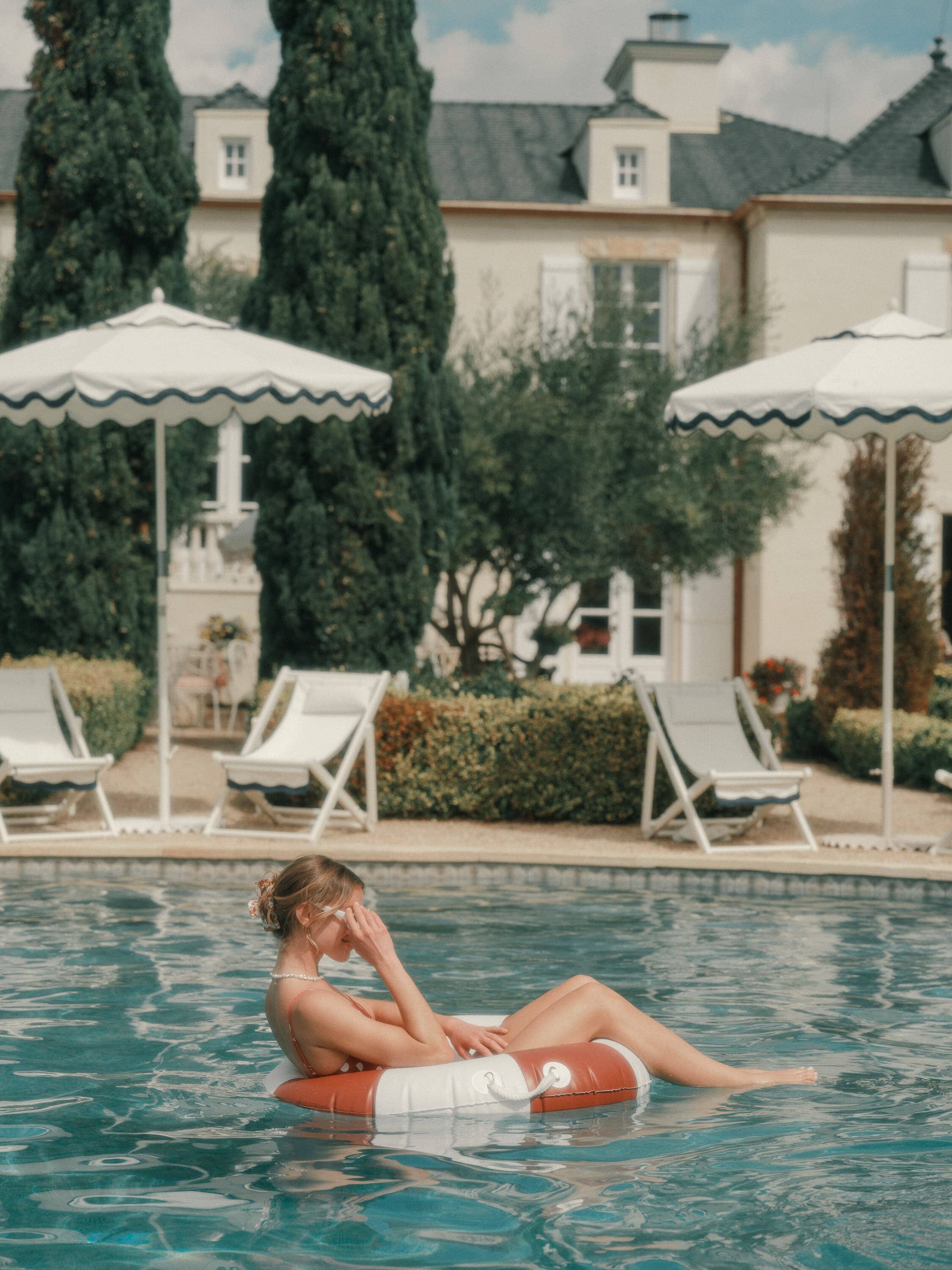 girl floating in a pool ring