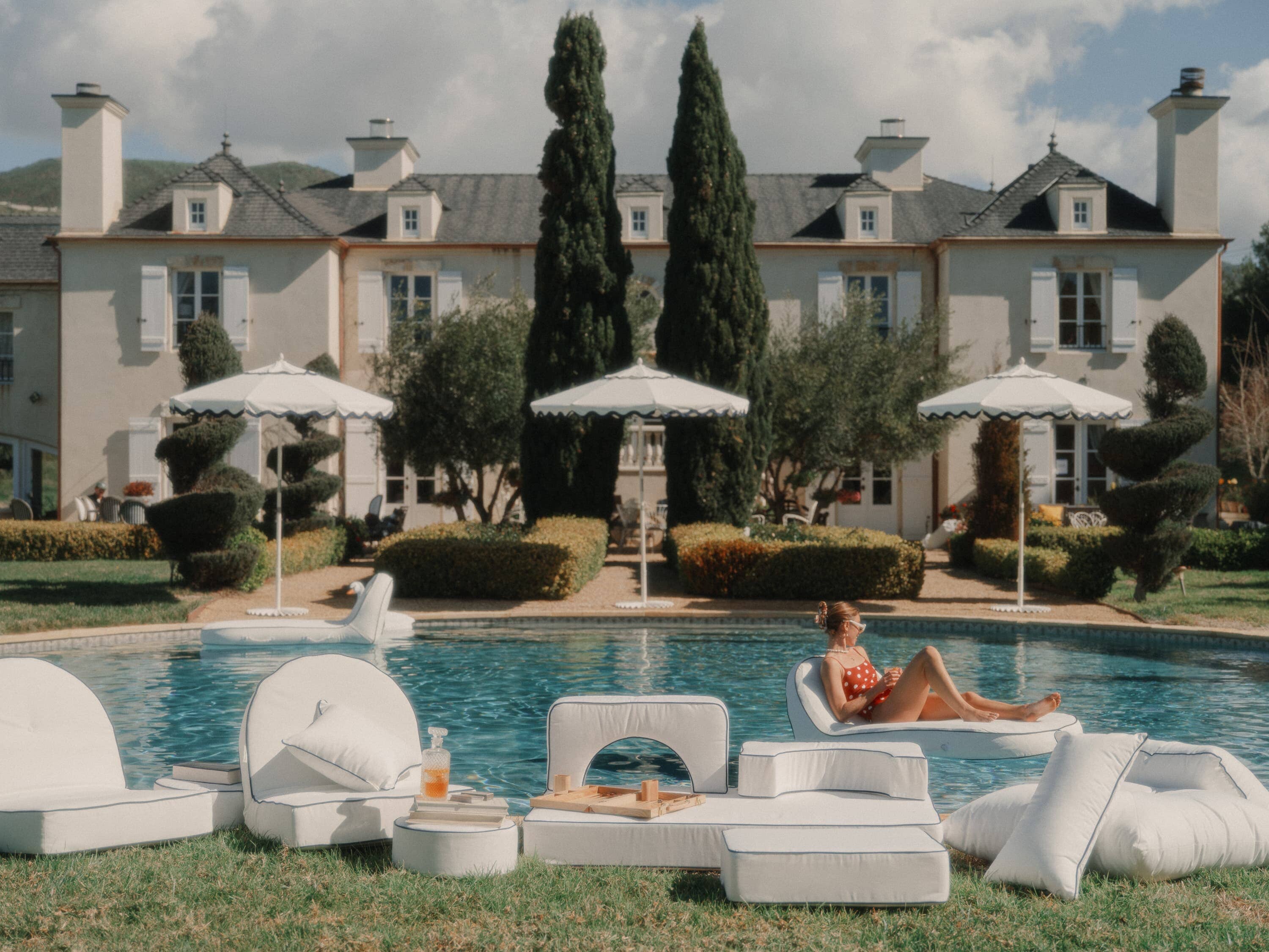 White outdoor cushions next to a pool