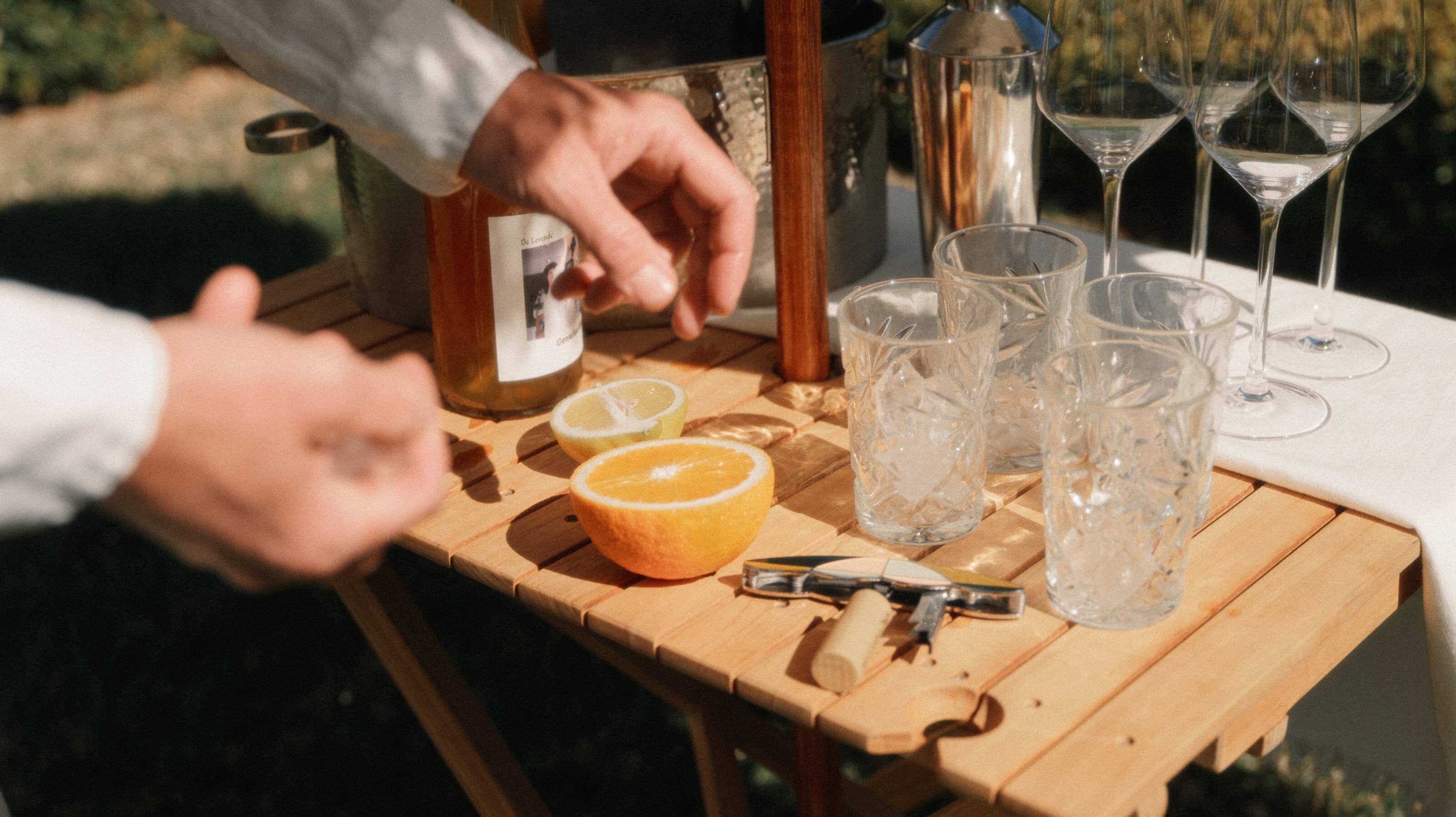 Outdoor picnic setting with tall folding table with drinks and fruit